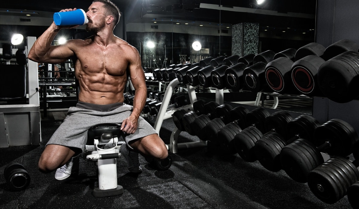 Fueling up after a workout session in a modern gym with strength training equipment