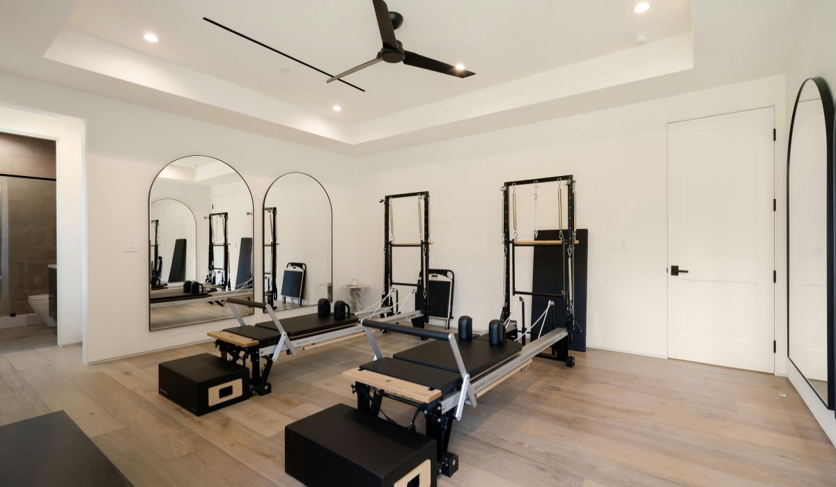 Vertical storage solution for fitness gear in a modern gym setting with ample natural light